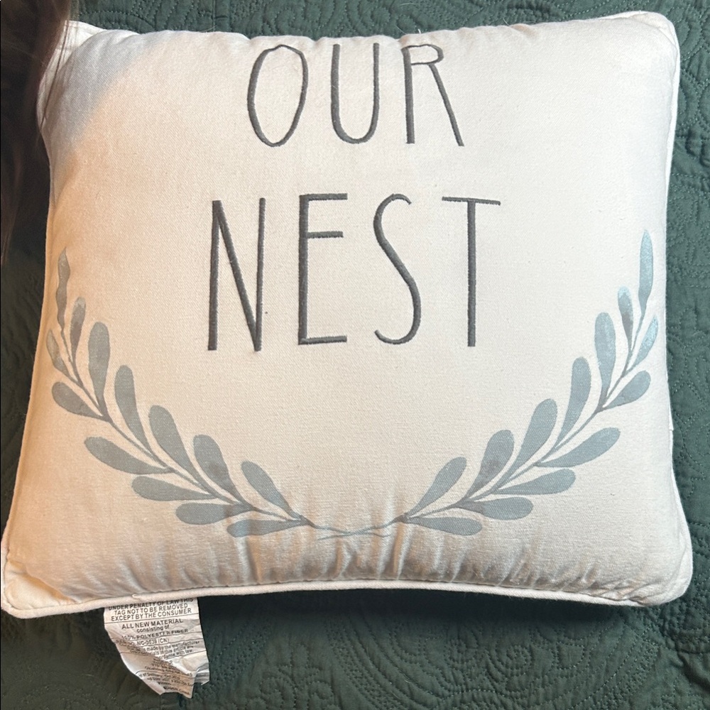 White Pillow with 'Our Nest' Design